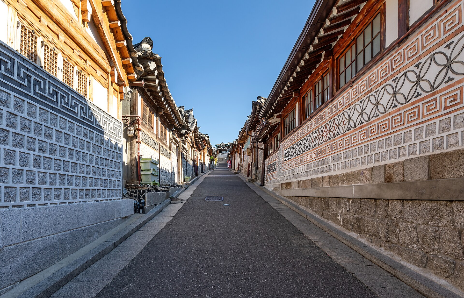 Traditional hanok houses along Bukchon-ro 11-gil under a blue sky in Seoul