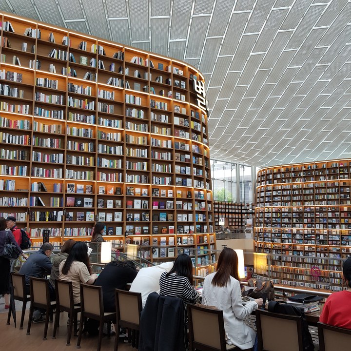 Tall bookshelves and reading area inside Starfield Library at COEX Mall in Seoul